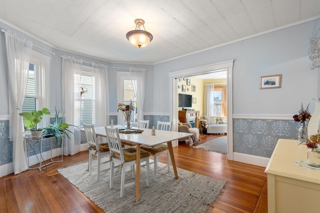 89 Bromfield Road Somerville, MA 02144 - Photo 9 of 41 a view of a dining room with furniture window and wooden floor