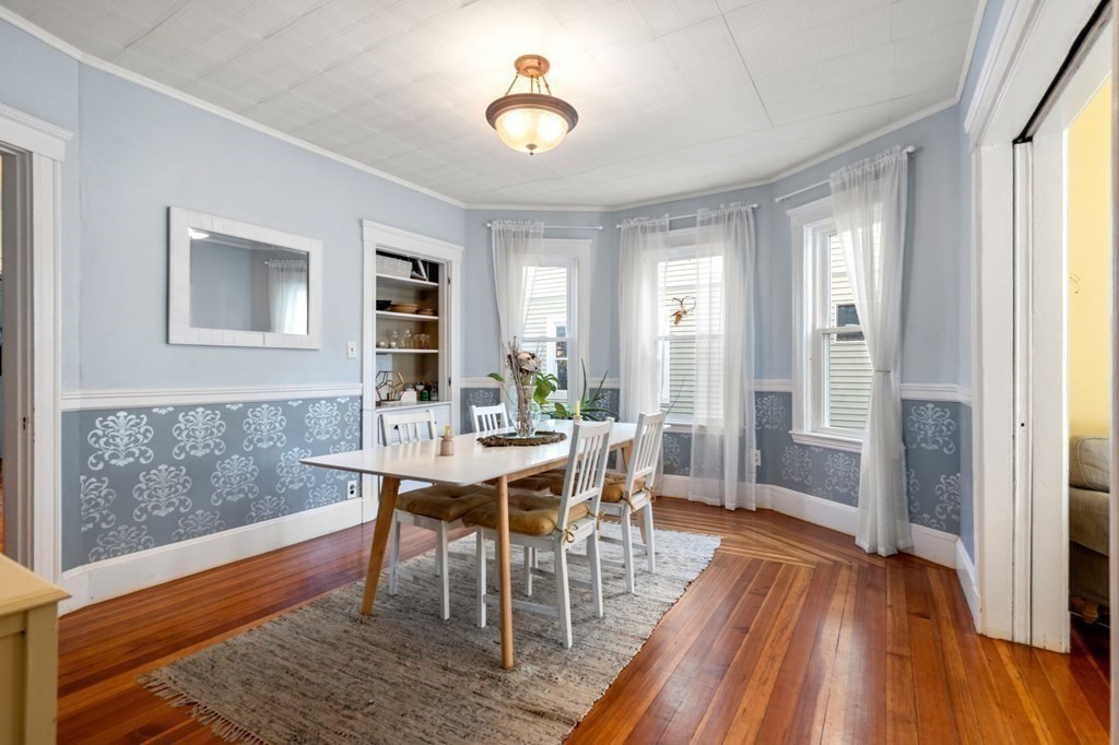89 Bromfield Road Somerville, MA 02144 - Photo 10 of 41 a view of a dining room with furniture window and wooden floor