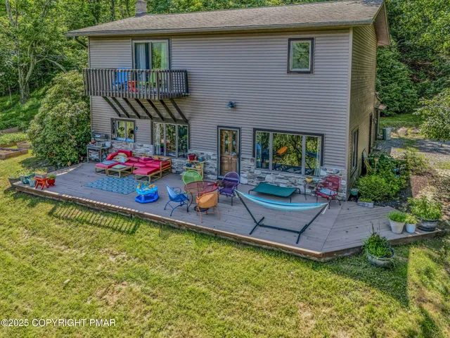 a front view of house with outdoor seating and yard