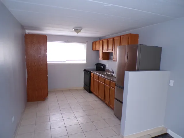 a kitchen with stainless steel appliances a refrigerator and a stove