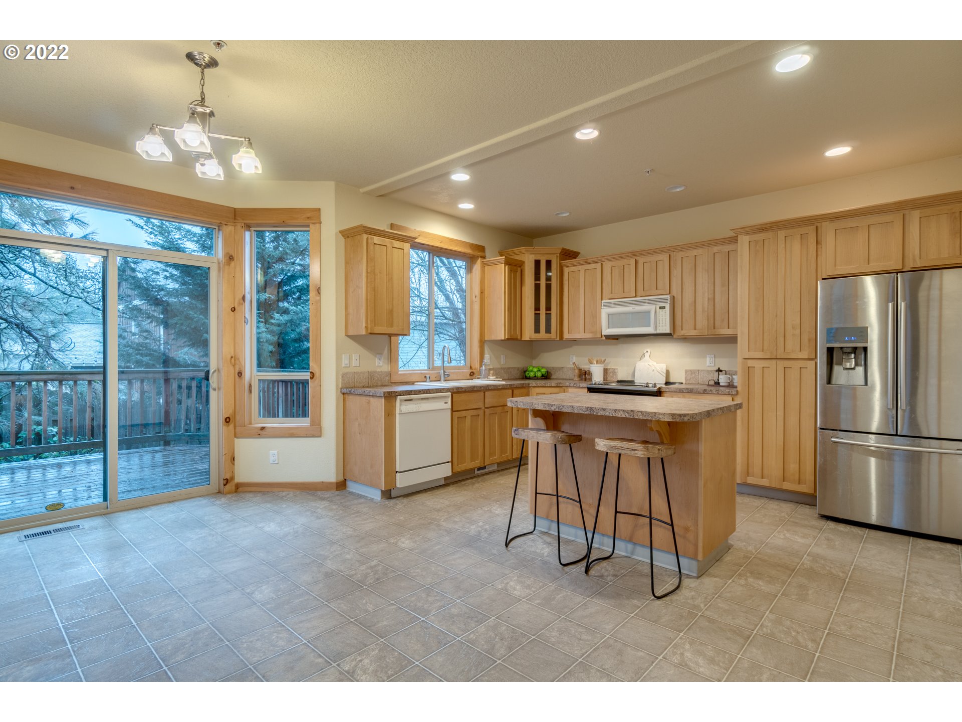 640 Southwest Trout Court Camas, WA 98607 - Photo 7 of 32 a kitchen with table chairs refrigerator and cabinets
