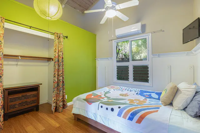 a bedroom with a bed and a flat screen tv