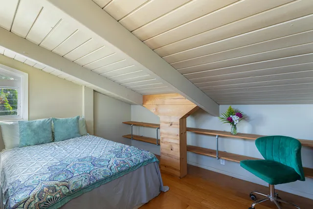 a bedroom with furniture and a wooden floor