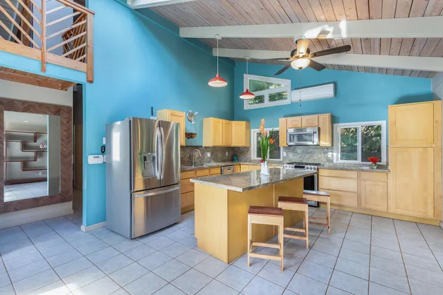 a kitchen with a refrigerator and table
