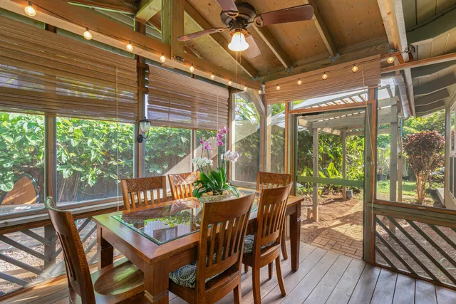 a view of a patio with table and chairs and wooden floor