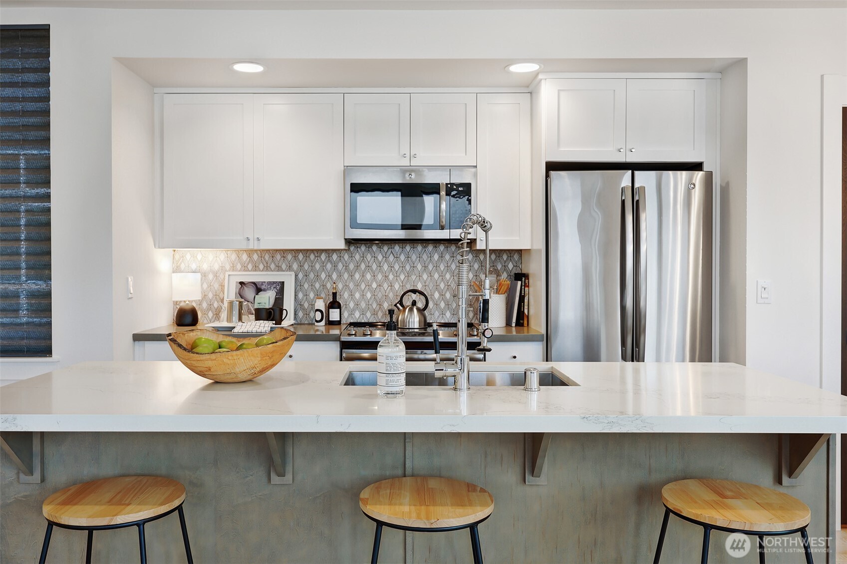 3717 South Dawson Street Seattle, WA 98118 - Photo 19 of 40 a kitchen with a sink and a stove with white cabinets