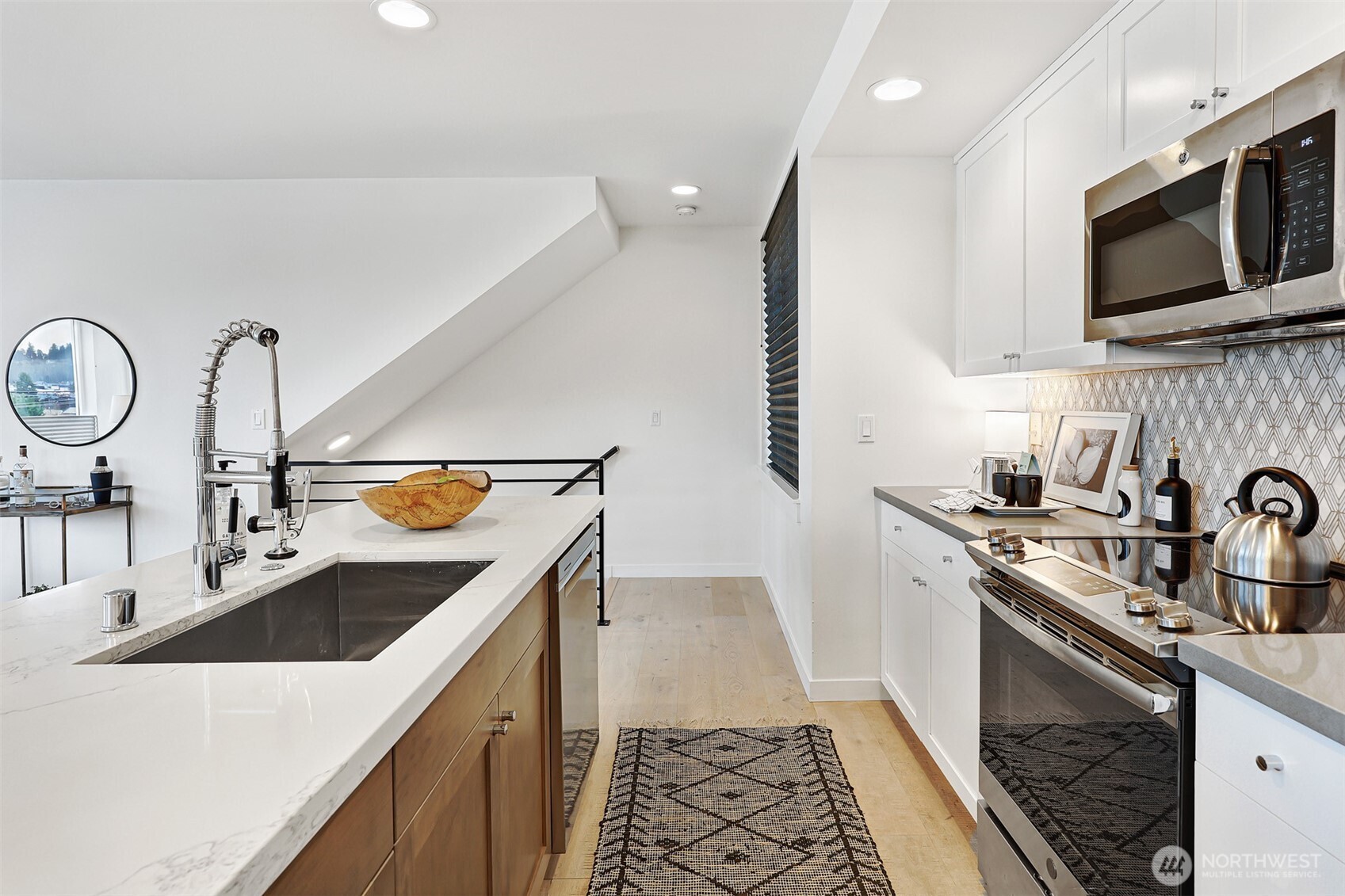 3717 South Dawson Street Seattle, WA 98118 - Photo 20 of 40 a kitchen with a sink and a stove top oven with wooden floor