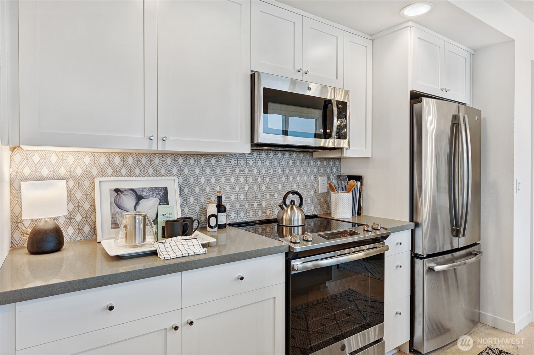 3717 South Dawson Street Seattle, WA 98118 - Photo 21 of 40 a kitchen with stainless steel appliances a sink a refrigerator and cabinets