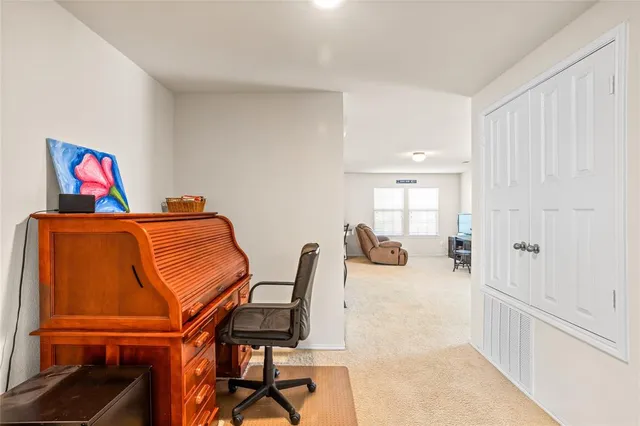 a bedroom with a bed and a chair