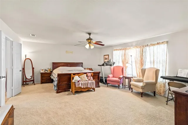a bedroom with bed and a large window