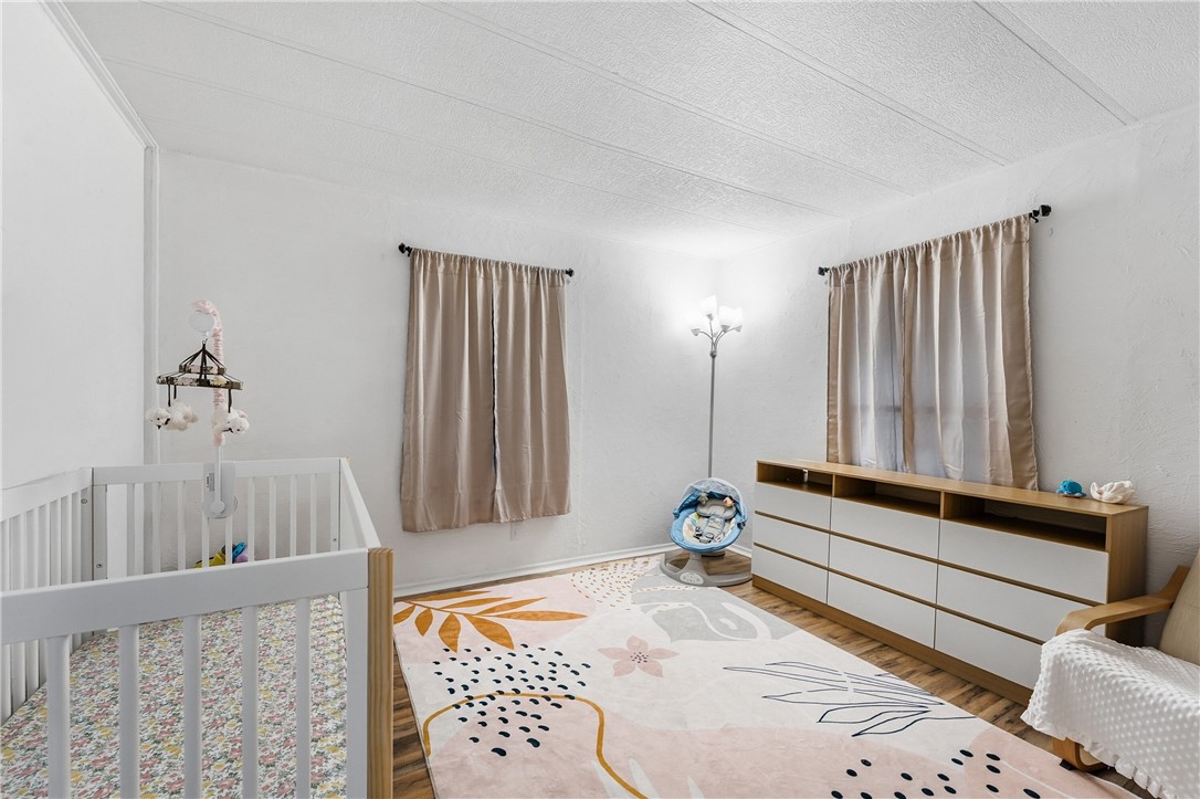 566 Dolphin Circle Sebastian, FL 32976 - Photo 16 of 36 a bedroom with a bed and wooden floor