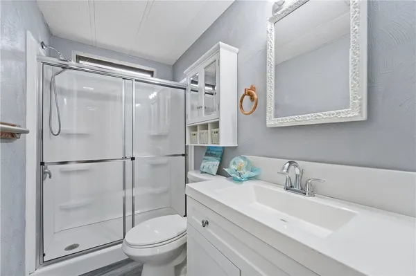 a bathroom with a sink toilet and shower