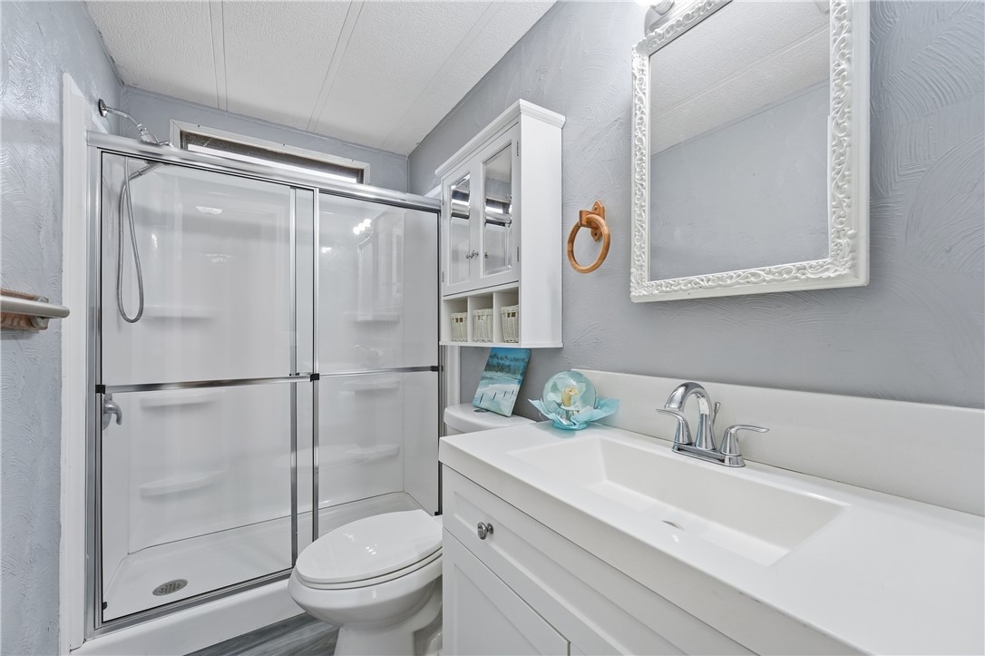 566 Dolphin Circle Sebastian, FL 32976 - Photo 20 of 36 a bathroom with a sink toilet and shower