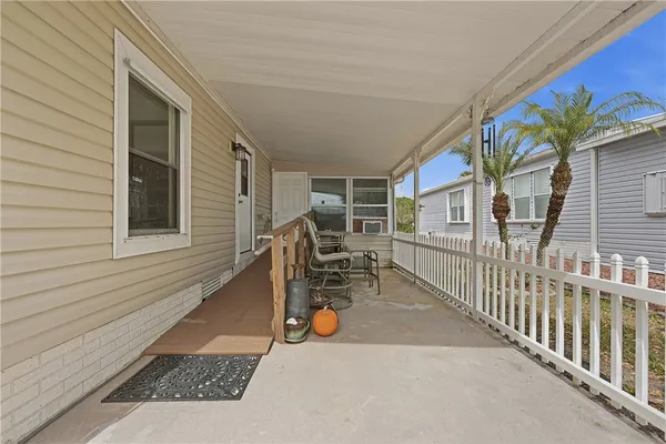 a view of a patio with table and chairs and potted plants