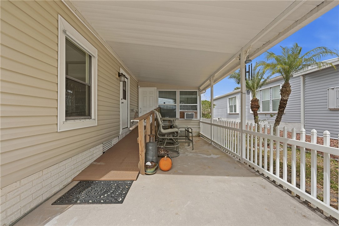 566 Dolphin Circle Sebastian, FL 32976 - Photo 3 of 36 a view of a patio with table and chairs and potted plants