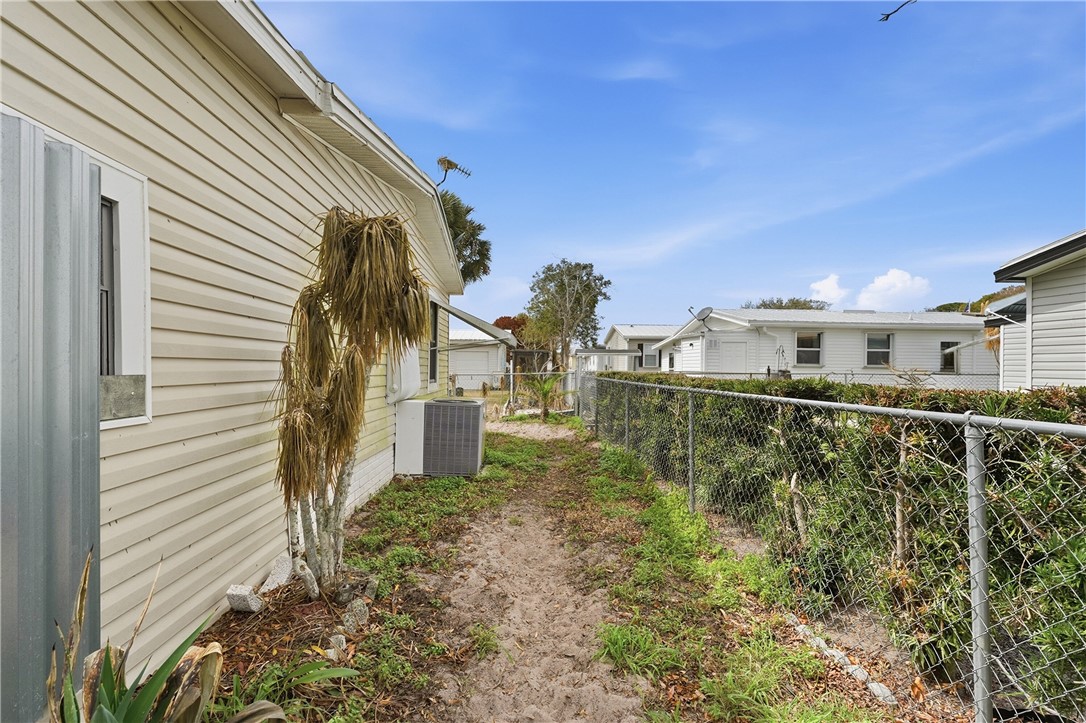 566 Dolphin Circle Sebastian, FL 32976 - Photo 4 of 36 a view of a large building with a yard and plants