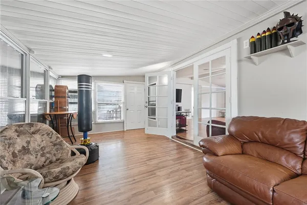 a living room with furniture a ceiling fan and a window