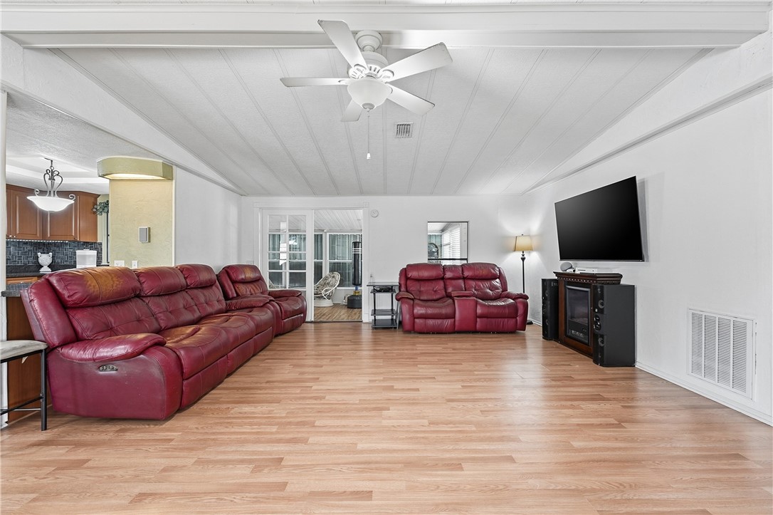 566 Dolphin Circle Sebastian, FL 32976 - Photo 7 of 36 a living room with furniture and a flat screen tv