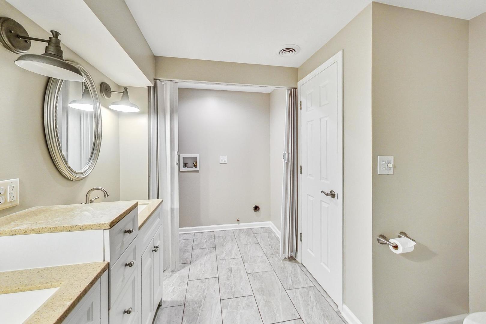 2782 Moraine Valley Road Wauconda, IL 60084 - Photo 19 of 24 a bathroom with a sink a mirror and a shower