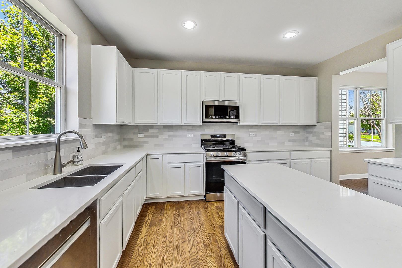 2782 Moraine Valley Road Wauconda, IL 60084 - Photo 3 of 24 a kitchen with a sink a stove a microwave and cabinets