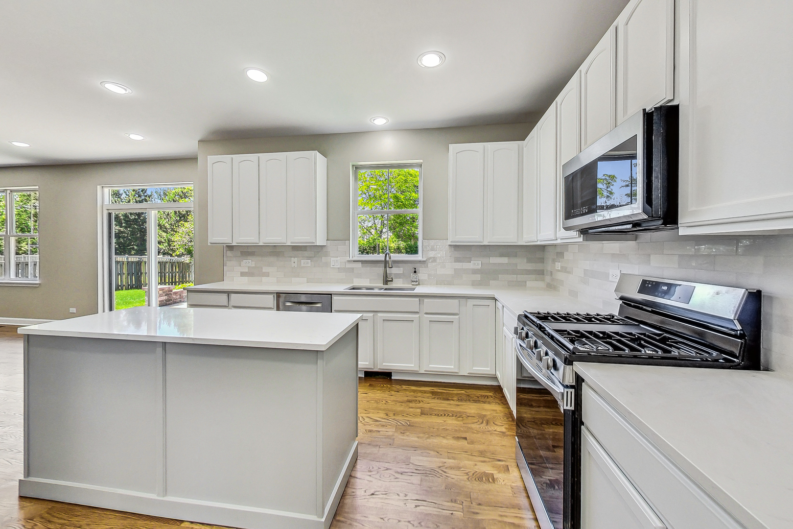 2782 Moraine Valley Road Wauconda, IL 60084 - Photo 4 of 24 a kitchen with stainless steel appliances granite countertop a sink a stove a microwave a sink a refrigerator and cabinets