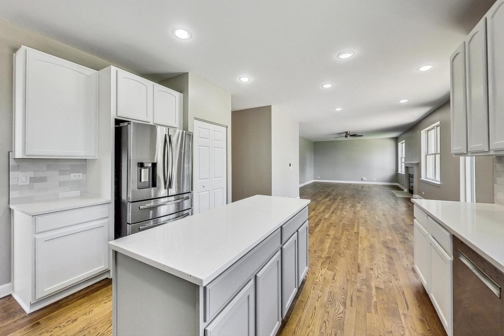 2782 Moraine Valley Road Wauconda, IL 60084 - Photo 5 of 24 a large kitchen with a center island wooden floor and stainless steel appliances