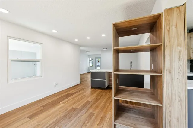 a view of a bedroom with wooden floor and bedroom