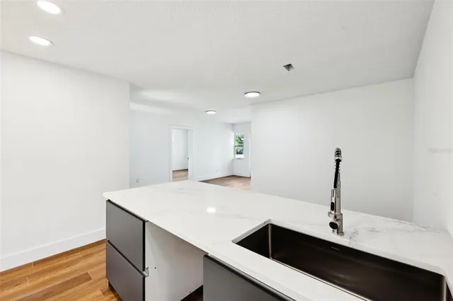 a view of a room with wooden floor and white walls