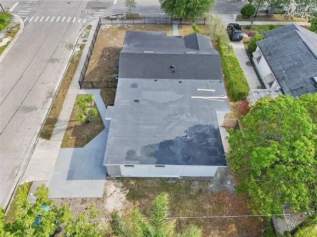 a view of a house with a big yard and potted plants