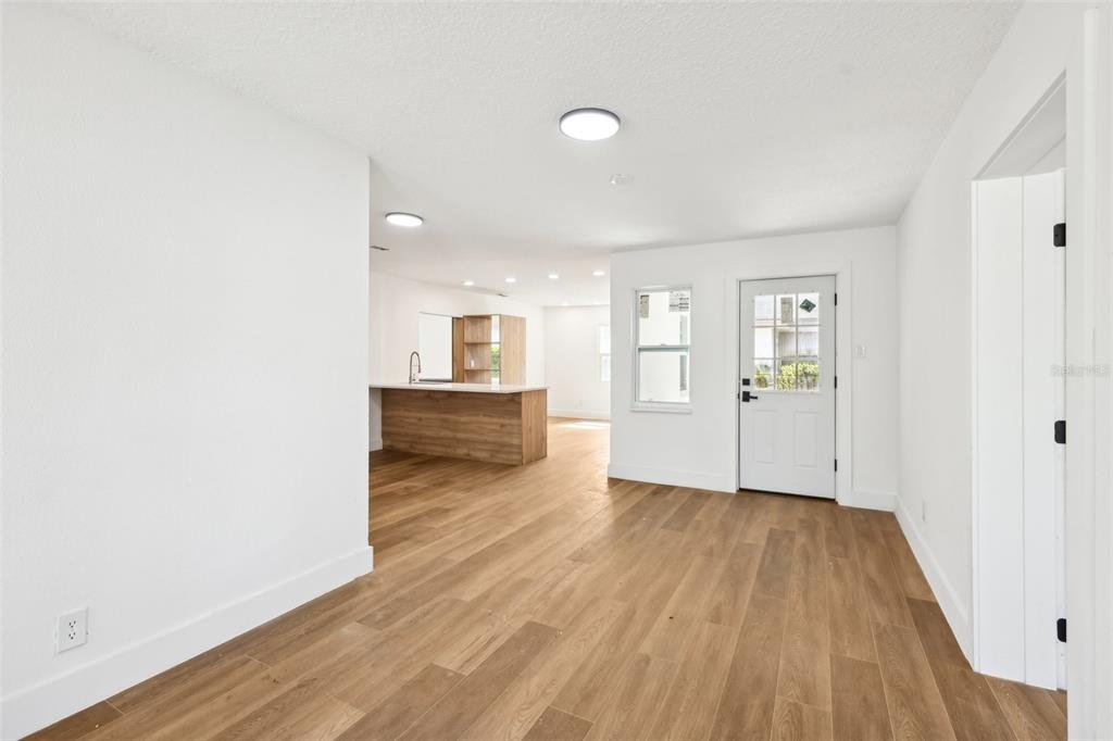 730 West Swoope Avenue Winter Park, FL 32789 - Photo 7 of 72 an empty room with wooden floor and windows