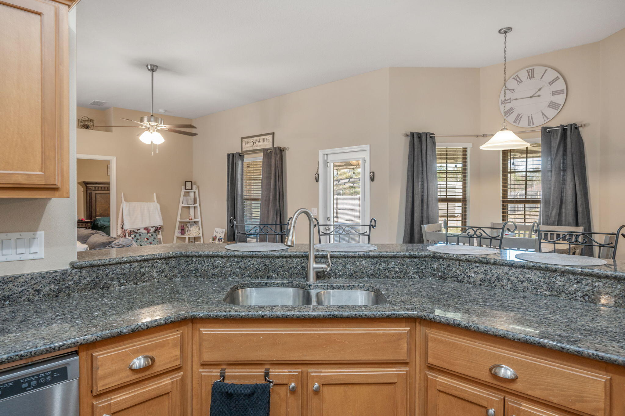 2342 Genevieve Way Crestview, FL 32536 - Photo 11 of 41 a kitchen with kitchen island granite countertop a sink a window and stainless steel appliances