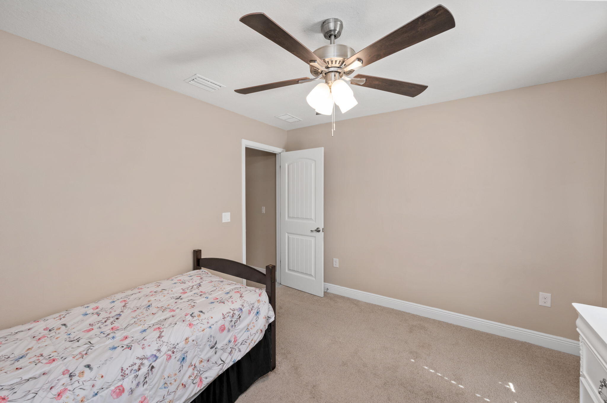 2342 Genevieve Way Crestview, FL 32536 - Photo 25 of 41 a bedroom with a bed and a chandelier