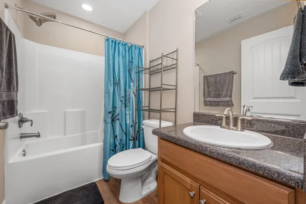 a bedroom with a bed and a ceiling fan