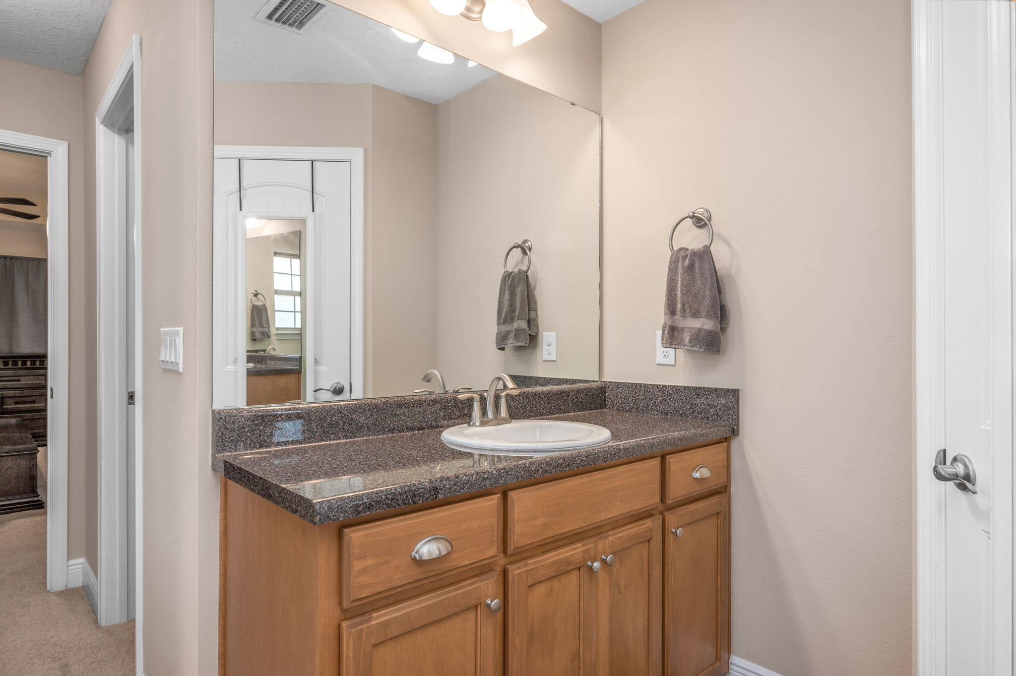 2342 Genevieve Way Crestview, FL 32536 - Photo 30 of 41 a bathroom with a granite countertop sink and a mirror