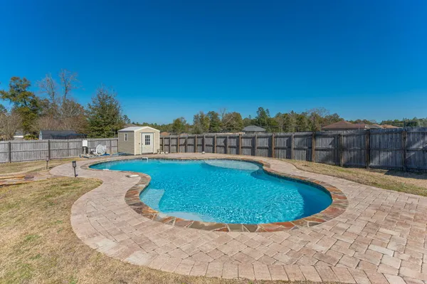 a bathroom with a granite countertop sink and a blue painted wall