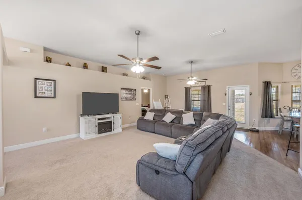 a living room with furniture and kitchen view