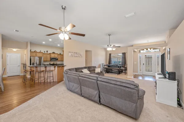 a kitchen with kitchen island granite countertop a sink a window and stainless steel appliances