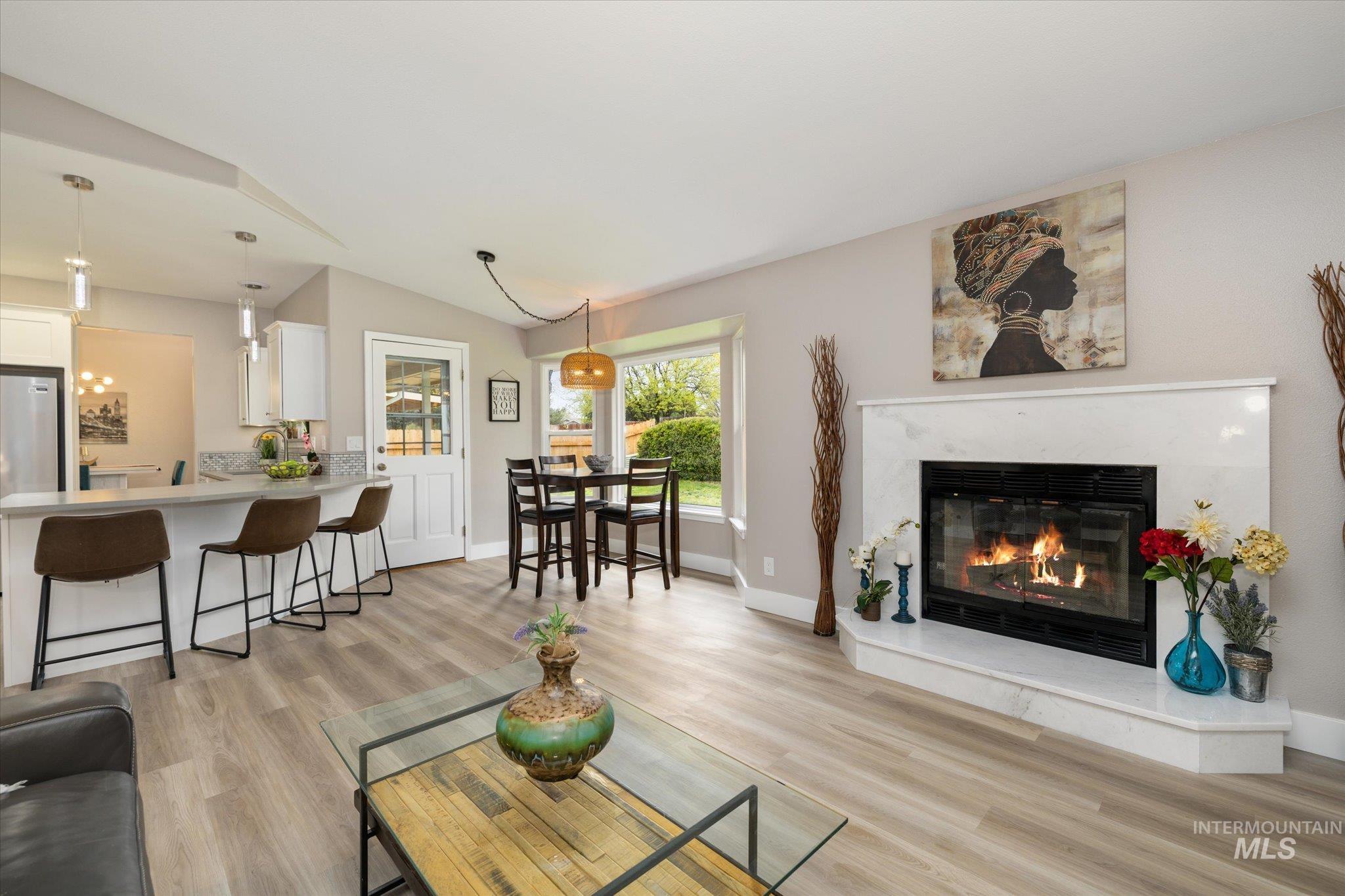 2250 North Amethyst Avenue Meridian, ID 83646 - Photo 27 of 50 Living area featuring a high end fireplace, light wood finished floors, and lofted ceiling