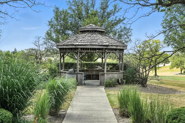 a view of a backyard with chairs