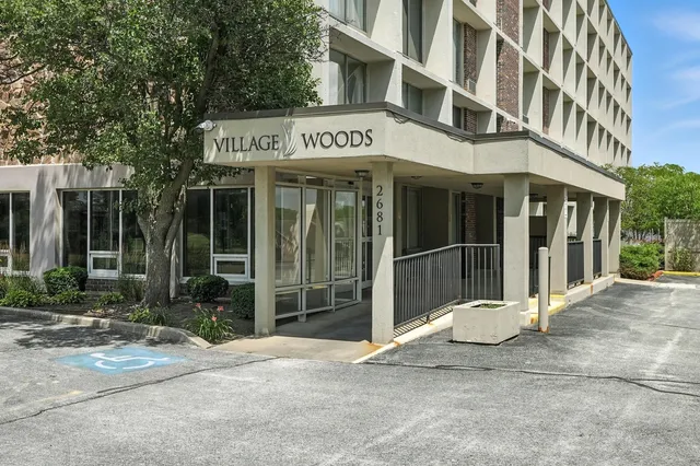 a view of a building with a large window and plants