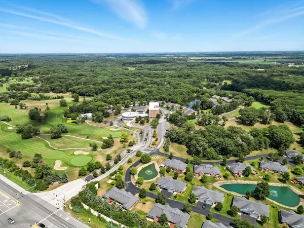 an aerial view of residential houses with outdoor space
