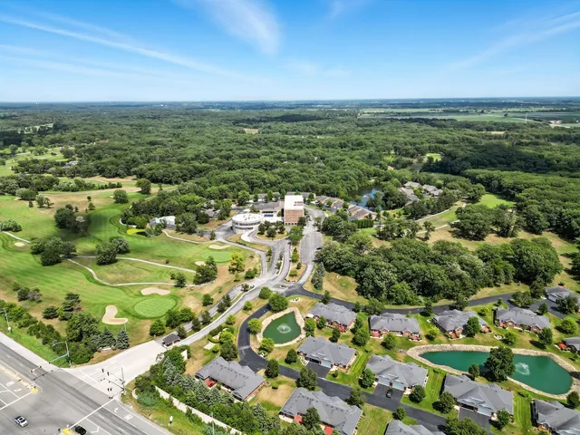 an aerial view of residential houses with outdoor space