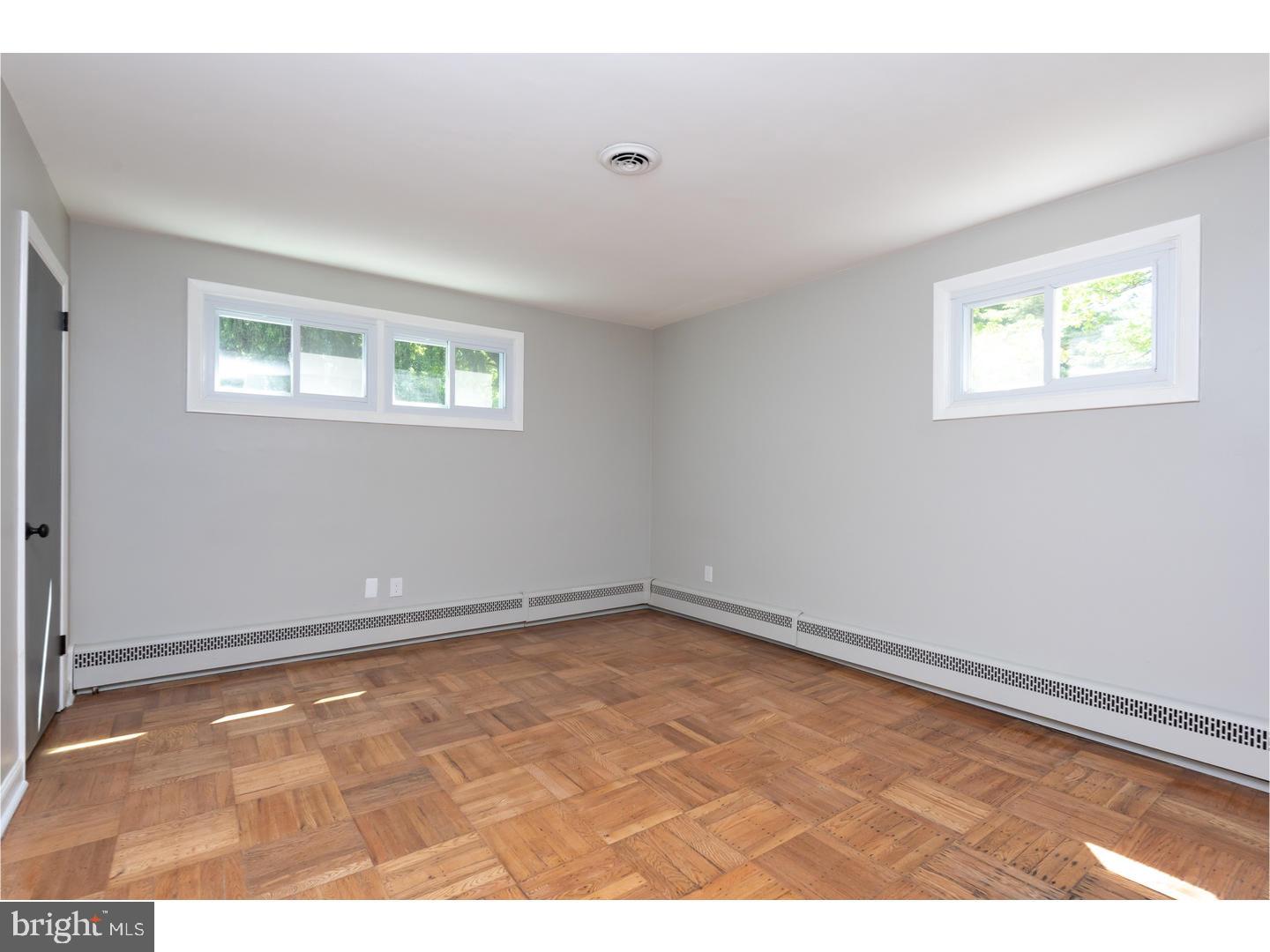 150 South Cedar Hollow Road Paoli, PA 19301 - Photo 17 of 23 an empty room with wooden floor and windows