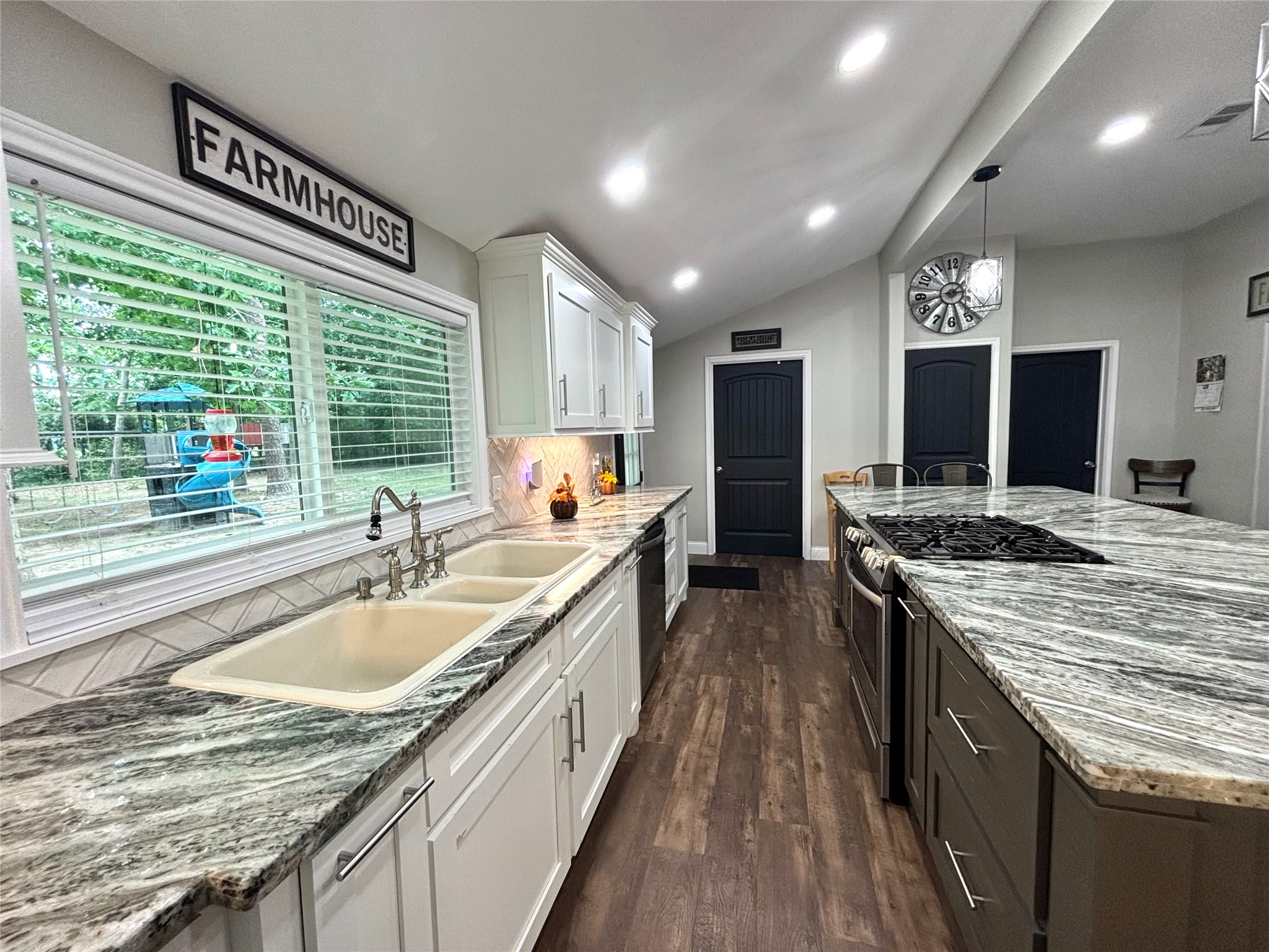 516 County Road 4800 Warren, TX 77664 - Photo 17 of 50 a kitchen with kitchen island granite countertop a large center island and a stove