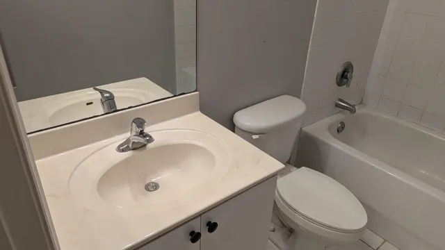 a bathroom with a sink and mirror with toilet