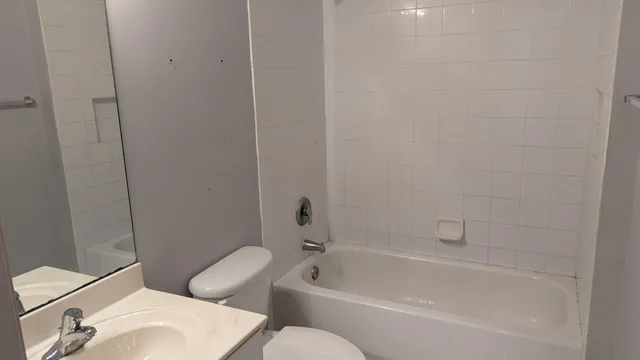a white bath tub sitting next to a white toilet