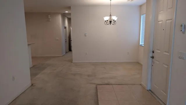a view of a chandelier in big room and chandelier