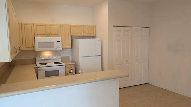 a kitchen with cabinets and stainless steel appliances