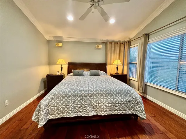 a bedroom with a large bed and a chandelier