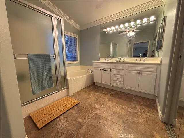 a spacious bathroom with a granite countertop sink mirror and a bathtub
